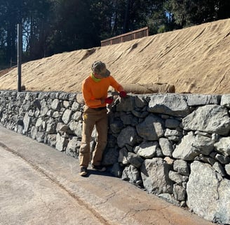 man working on rock wall in el paso, texas
