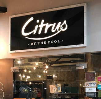 a restaurant with a sign that says citrus by the pool