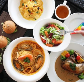 a table with plates of food and a hamburger burgers