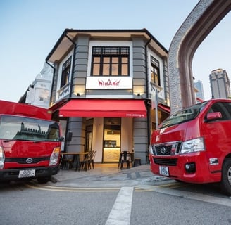 two red trucks parked in front of a building