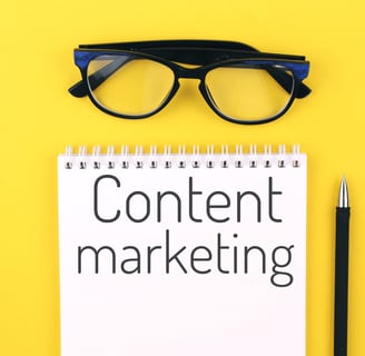 Notebook with the words Content marketing against a yellow background