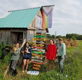 a group of friends outside the farm stand