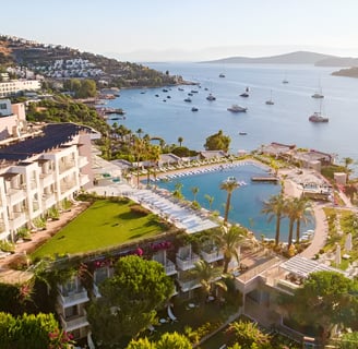 a hotel in front of a large body of water with a lot of boats in it