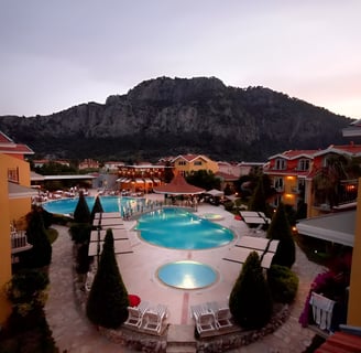 a pool with a mountain in the background in marmaris, turkey