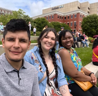 a Mexican man and a black and mixed women sitting and smiling 