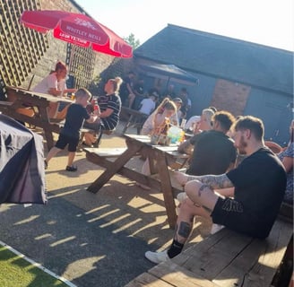 a group of people sitting in a beer garden