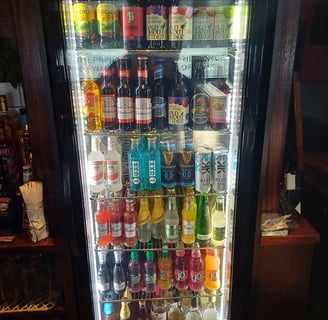 a refrigerator with a glass door that is filled with alcohol