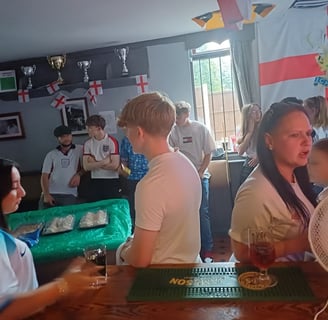 a group of people standing around a bar