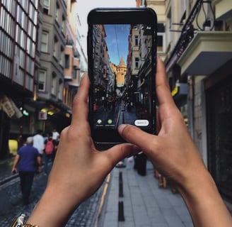 a person holding a cell phone in their hand