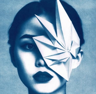 Close-up of a woman with blue-toned skin, dark lips, and a geometric paper structure covering her ri