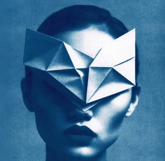Close-up of a woman with a dark lip color, wearing a white geometric paper mask covering her eyes an