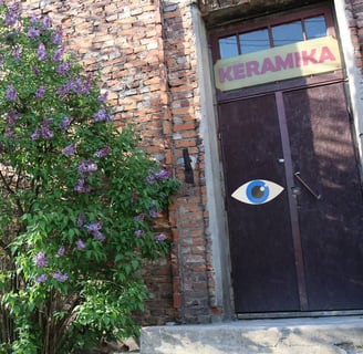 Entry to studies. A large exhibition sign - an eye - is stuck in front of the exhibition. 