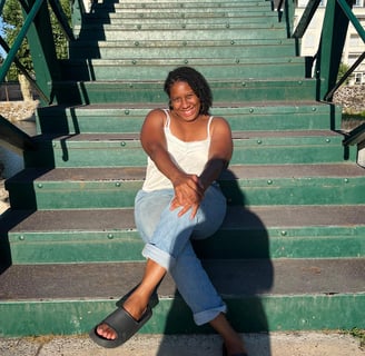 a woman sitting on a set of stairs