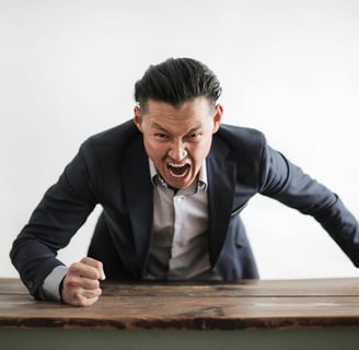 a man in a suit and tie is screaming at someone