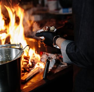 a person cooking food in a potted potted on a stove