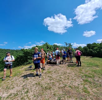people grouped on a hilltop in sunshine