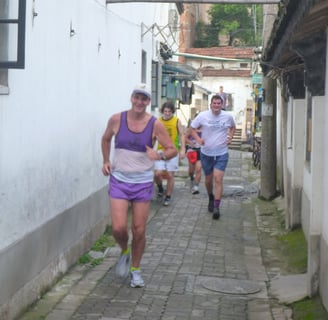men running in a narrow alley