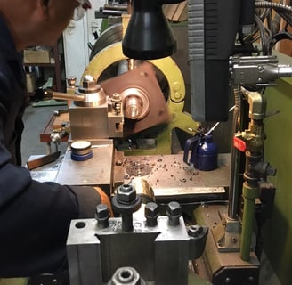 a man in a blue jacket is working on a machine