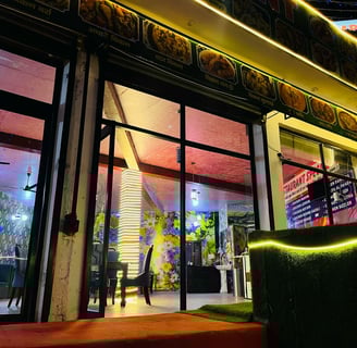 a restaurant with a large window and a green couch in Sarpanch Restaurant Bareilly Fatehganj