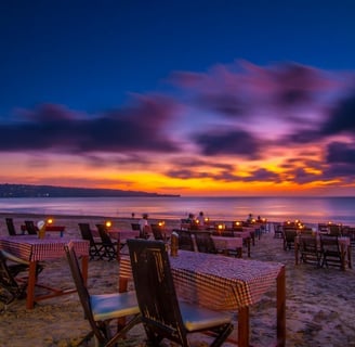 a beach with a table setting for dinner