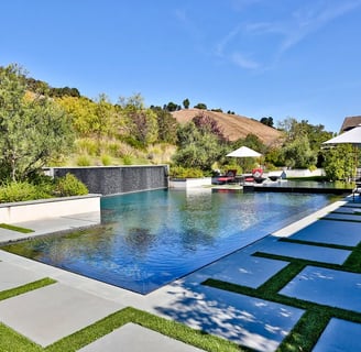 Aerial view of a custom luxury pool with lighting and spa in a Palo Alto backyard