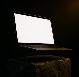 a laptop computer sitting on a rock in the dark