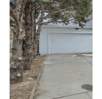 a fire hydrant sitting on the side of a driveway