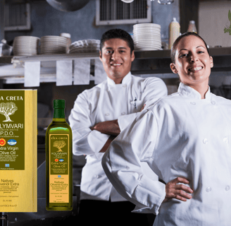 two chefs in white uniforms standing in a kitchen