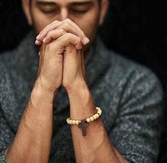 A young man praying with his eyes closed