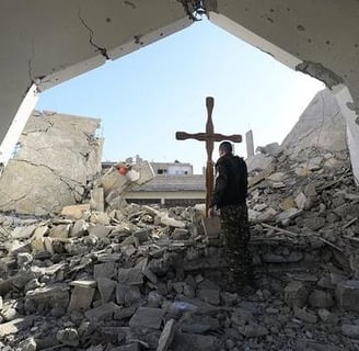 a man standing in a room with a cross on it