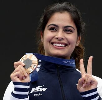 a woman holding a medal and a medal
