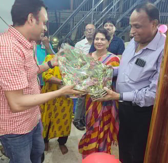 Handing a bouquet of flowers to Chief Guest