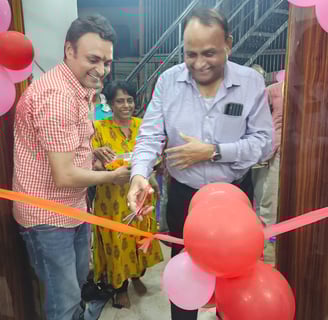 Chief guest cutting a ribbon tied to a ribbon