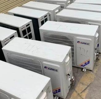 a bunch of air conditioners are lined up in a row