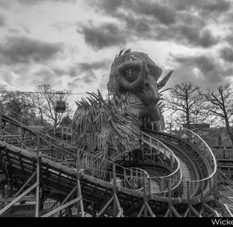 wooden roler coaster track with thr rear of the wicker man and some sky ride gondolas 