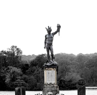 A Statue of Perseus holing the head of medusa in black and white