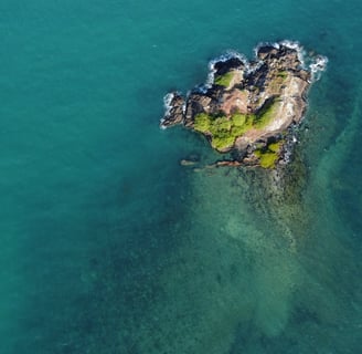 a small island with a small island in the middle of the ocean
