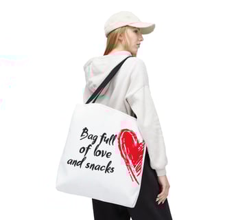 a woman in a white shirt and black pants with a red heart baguet bag