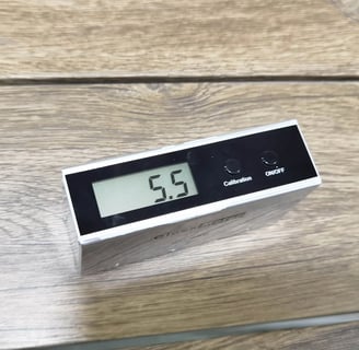 Brightness meter on an antique-finished solid wood table, indicating precise luminosity control for 