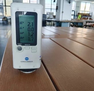Konica Minolta colorimeter measuring color consistency on an HDPE outdoor furniture surface