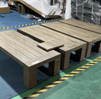 Quality control comparison of finished patio tables with a sample panel, demonstrating color