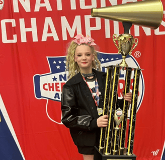 baylor holding an nca championship trophy