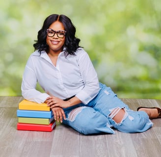 a woman sitting on a wooden floor with books