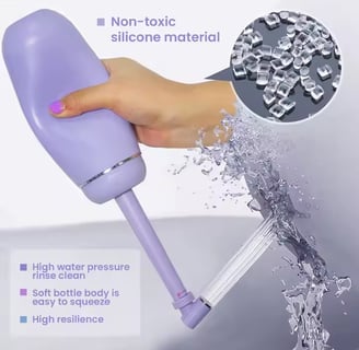 a hand holding and squeezing a portable water with water coming out of the nozzle