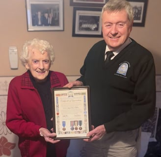 John presenting a Congo Commemorative scroll to the Mullins Family