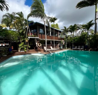 a pool with a house in the background