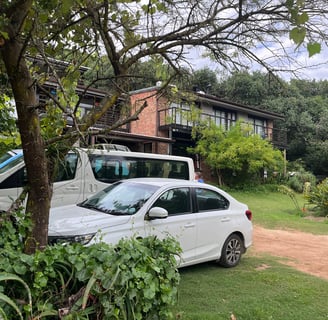 a white car parked in front of a house