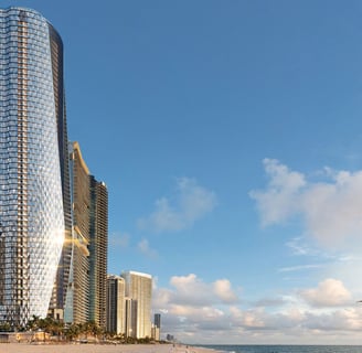 a beach with a large building in the background