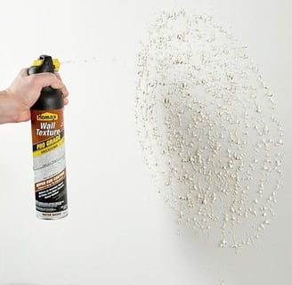 a person holding a spray canister of a spray canister