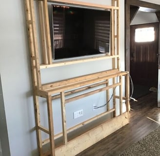 a television screen mounted on a wall in a living room